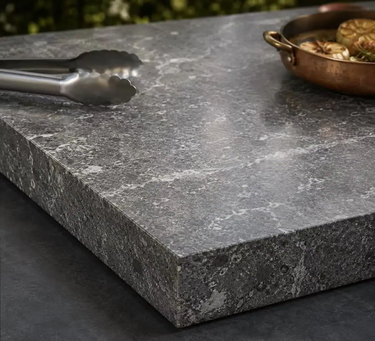 Stone countertop for outdoor BBQ cabinet prep and cooking zone