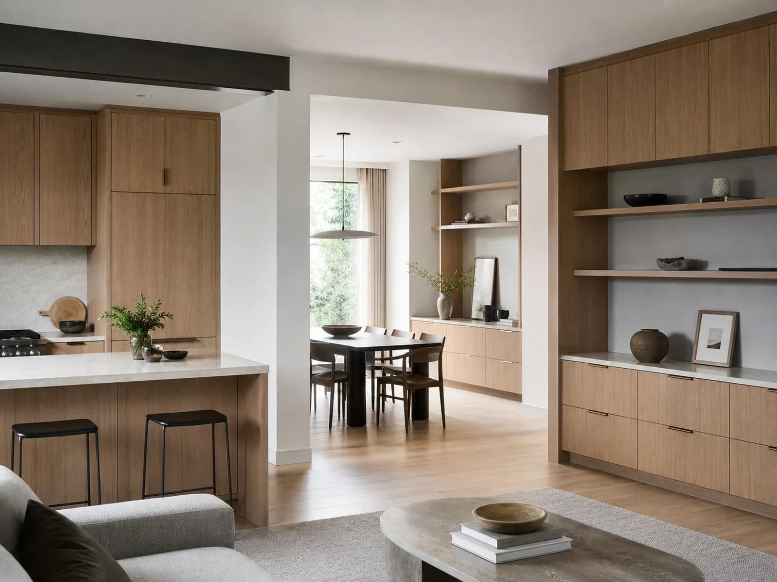 Open-plan home with coordinated natural oak cabinetry in kitchen dining and living areas.
