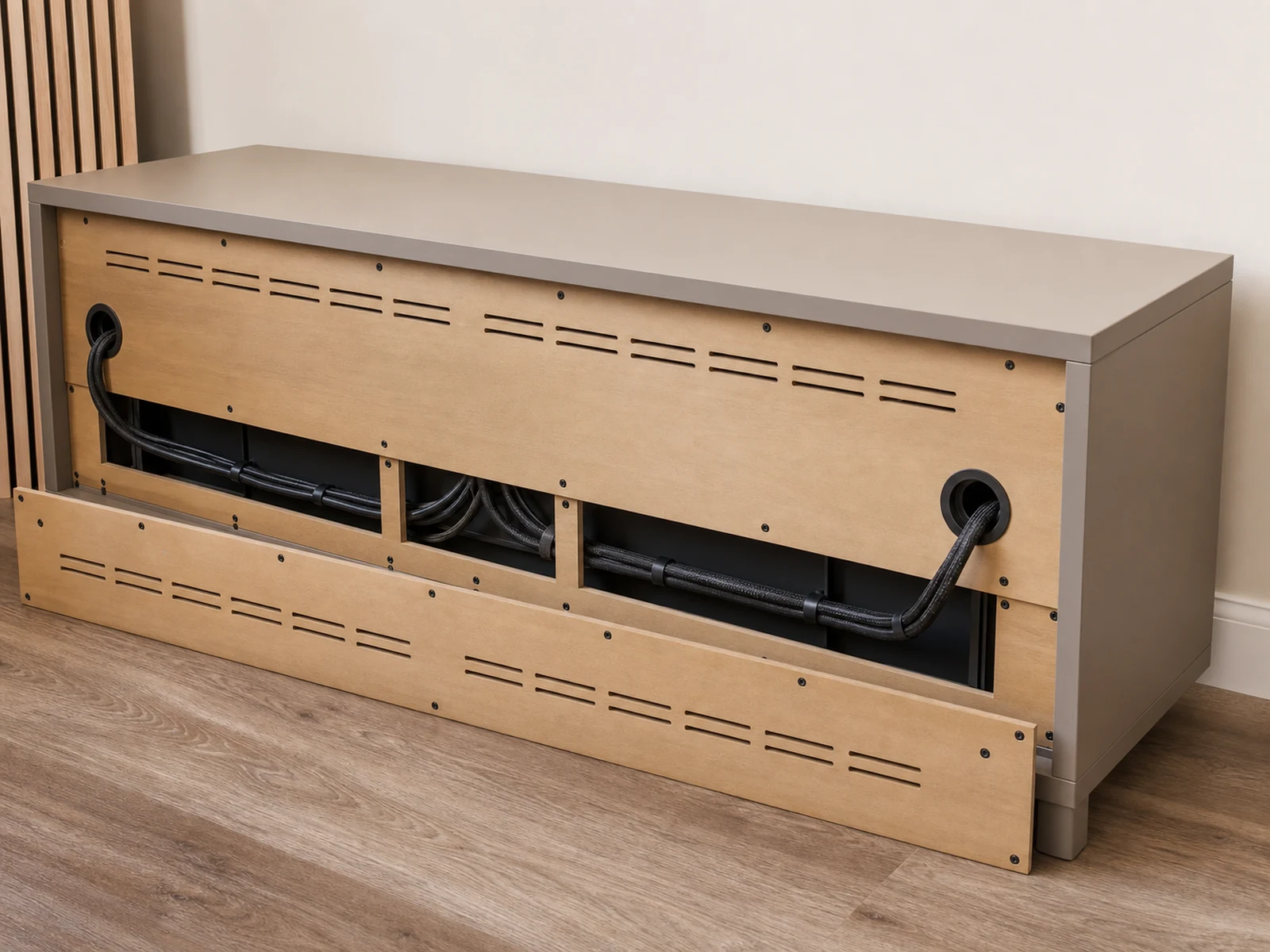 Rear panel of a low TV console with cable pass throughs, removable access panel and ventilation openings.